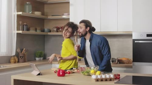 Couple Singing and Dancing in Kitchen