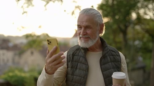 Senior Man Using Phone in the Evening Light