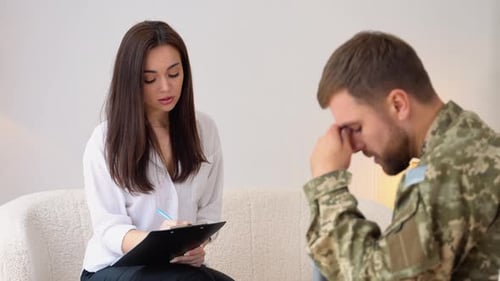 Upset Pensive Soldier Having Therapy Session With Psychologist In Office Soldier Suffering Mental