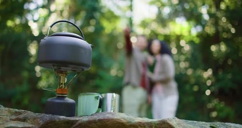 Camping Kettle and Mugs in Green Forest Setting