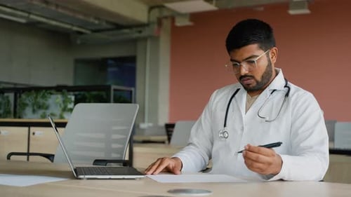 Tired Indian Doctor After a Long Clinic Day Dealing with Stress