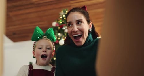 Mother and Child Opening Christmas Present with Joy