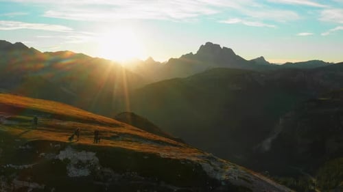 Group of People Hiking Up Mountain at Sunset in the Italian Alps Tre Cime Di Lavaredo