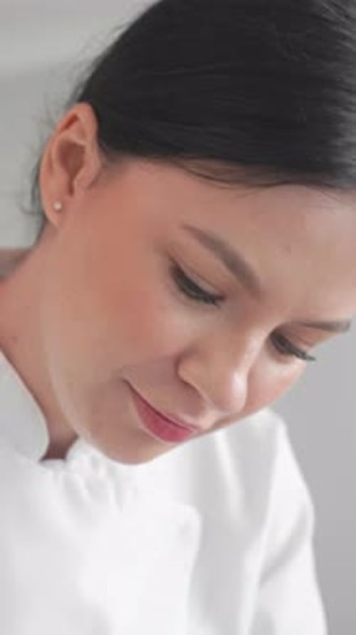 Woman's Focused Gaze: Close Up Portrait in White