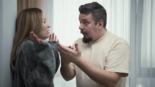 Couple Arguing Passionately During a Difficult Conversation Indoors
