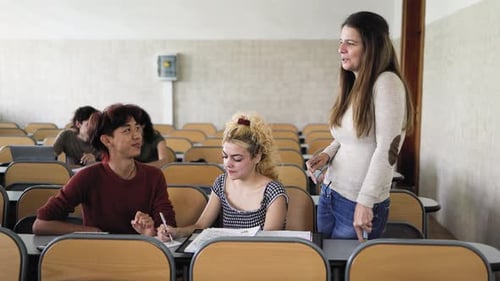 Young multiracial people studying inside university classroom