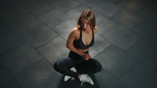 Athletic Young Woman in Black Sportswear Doing Stretching in Gym