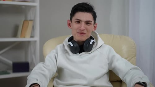 Young Adult Talking Directly to Camera Indoors