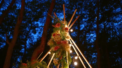 Floral Decoration with String Lights in Forest at Night