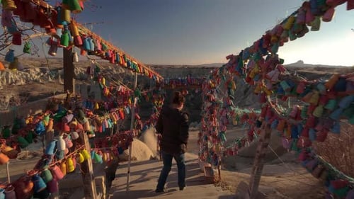 Girl Descending Stairs to Love Valley Viewpoint in Cappadocia, Passing by Shelves with Colorful Cera