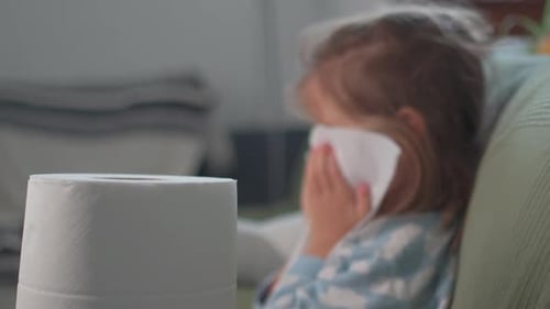 Young Girl Wipes Face With Tissues