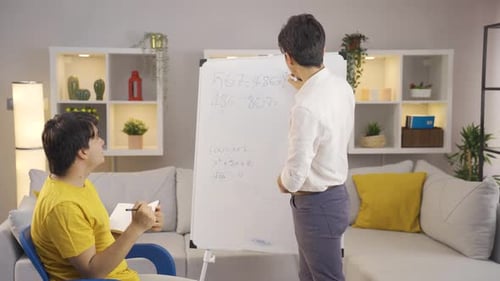 Young Adult Tutor Explaining Math to Student