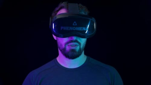Man Wearing Virtual Reality Headset in Dark Room