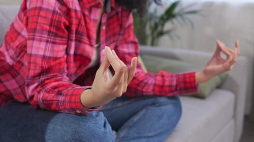 Woman in Yoga Pose Meditating at Home