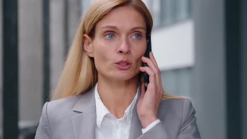 Serious Caucasian Adult Business Woman Talking Mobile Phone Call in City Businesswoman Female