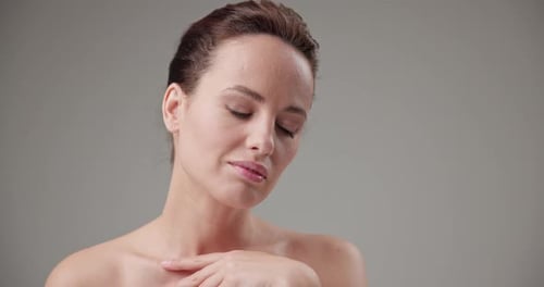 Elegant Woman Touches Her Neck and Shoulder