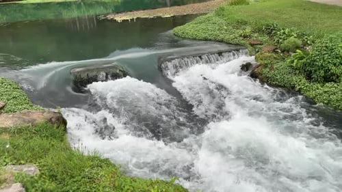water flowing fast over a small dam 4k 30fps