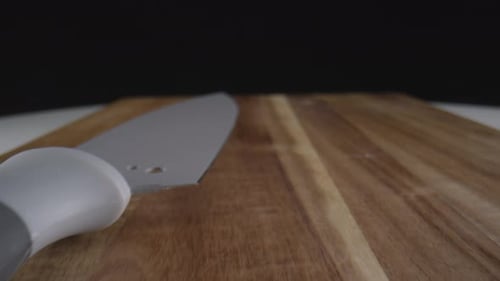 Tracking Shot of Wood Cutting Board and Knife