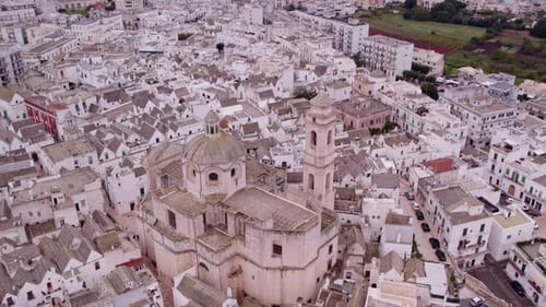 Aerial view of white village with cloudy sky, Italy.