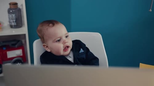 Baby in Suit Looking at Laptop Screen