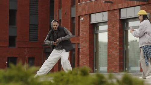 Youthful Dancer Performs for Phone Camera Outdoors