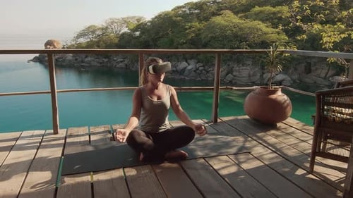 Woman Meditating Outdoors Wearing VR Headset on Deck