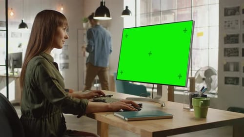 Beautiful Professional Creative Employee Works on Her Personal Computer with Big Green Screen Mock