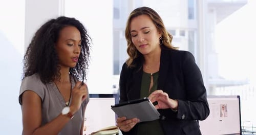 Professional Women Discussing Business in a Bright Office