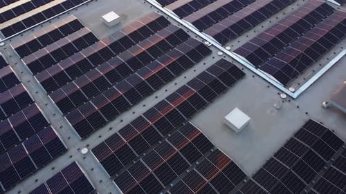 Rows of solar panels providing sustainable energy on commercial building rooftop