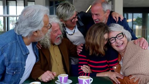Joyful Group of Senior Friends Having Fun Drinking Coffee at Cafeteria Bar