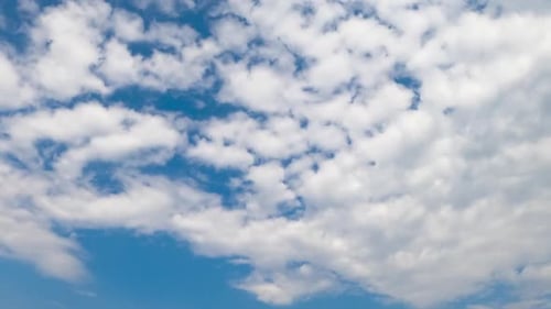 Clouds Floating Across Clear Blue Daytime Sky