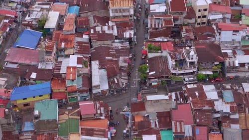 Top down aerial view of squalid poverty stricken slums lining Cebu City's downtown aera.