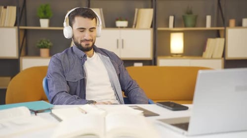 Young Man Listening to Music at Home