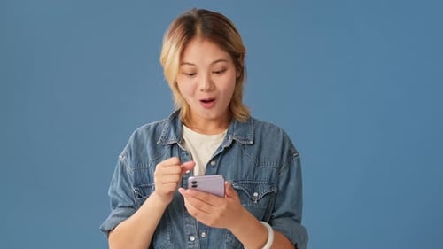 Excited Woman Celebrates Good News on Mobile Phone