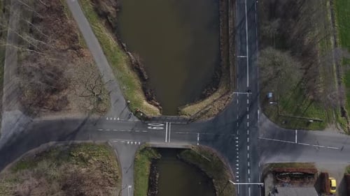 Drone shot of dutch landscape with canal and roads.