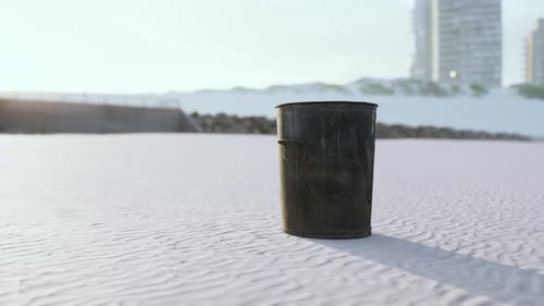 Gray Metal Garbage Bin or Trash Can on the Beach