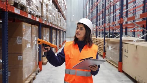 Female Warehouse Worker Scanning and Checking Inventory