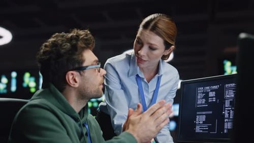 Data Center Analysts Working in Dark Server Room Closeup Programmers Discussing