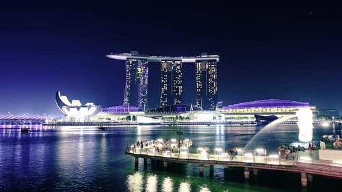 Singapore skyline time lapse at night over marina bay with city lights