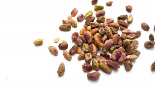 Fresh Pistachio Nuts Slide View On White Table Background