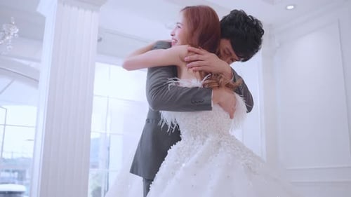 Asian attractive fiance couple kissing each other in wedding studio.