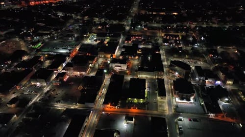 Small american town with straight avenues at night. American housing area with warm lighting streetl