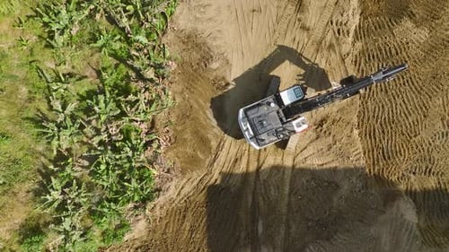 Aerial View of Excavator in Tropical Dirt Field