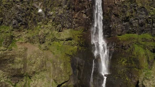 Pull out aerial view from close up to wide angle of the Bjarnafoss Waterfall in Iceland.
