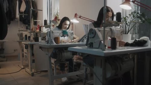 Female Seamstresses Works at Sewing Machines