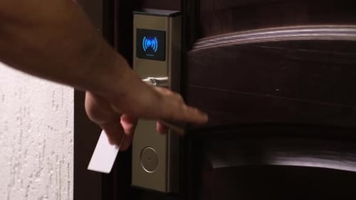 Man Opening Hotel Door with Electronic Card Key and Entering Room