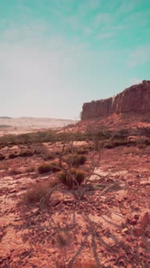 Barren Desert Landscape With Prominent Rock Formation