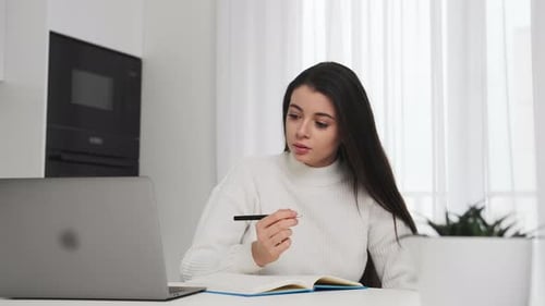 Young Adult Woman Working at Home With Laptop