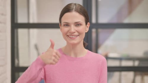Woman Gives Thumbs Up to Camera