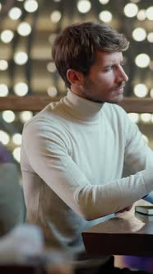 Freelancer Working on a Laptop Focused Man Typing on a Laptop Remote Work in a Cafe Vertical Video